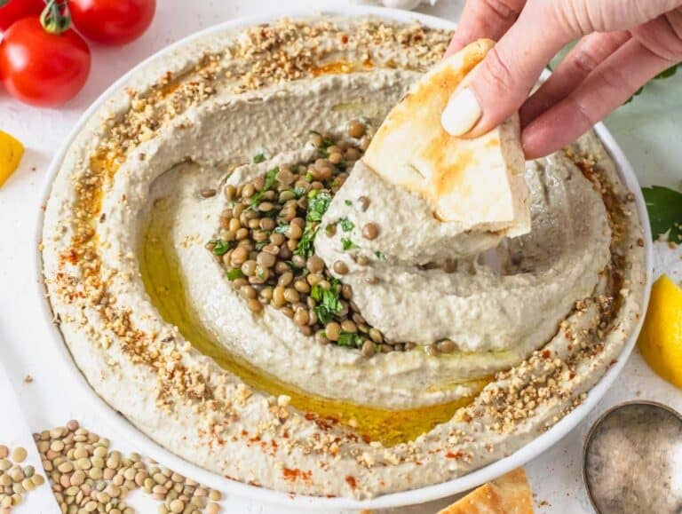 Lentil hummus served on a plate with pita bread