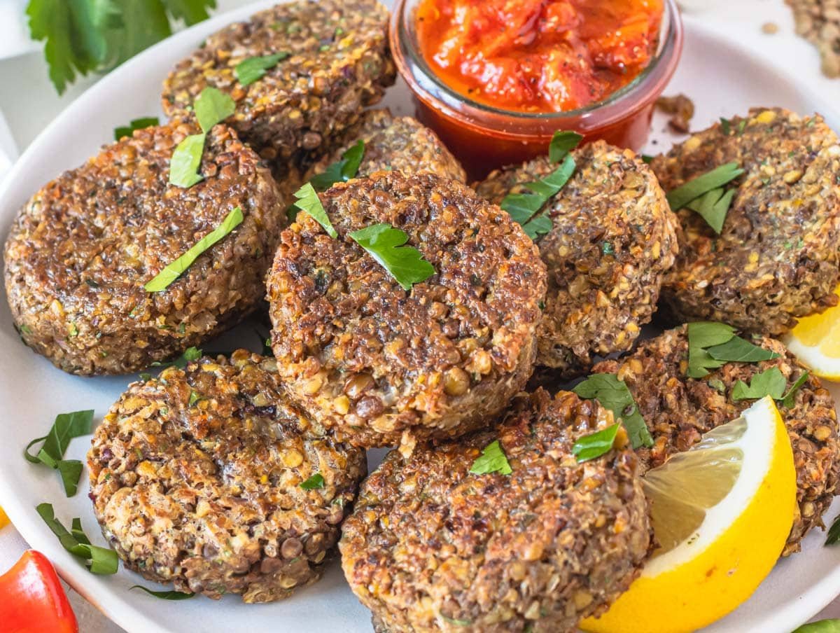Lentil patties with lemon wedges and fresh parsley