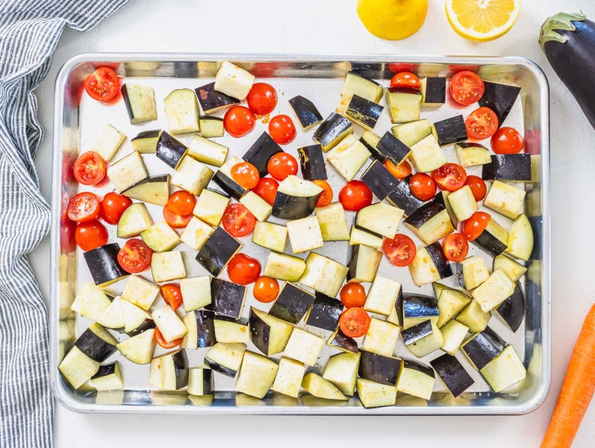 cubed eggplant and cherry tomatoes before roasting