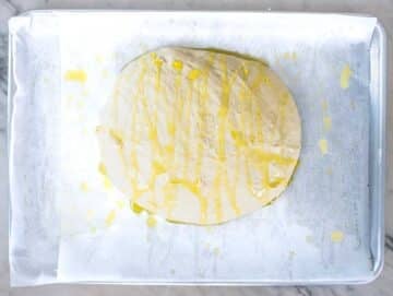 pizza dough with oil on a baking tray