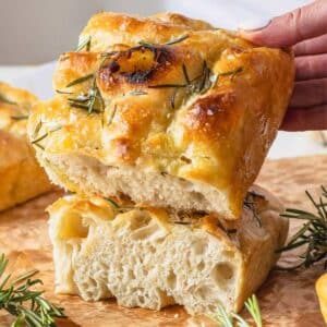 Focaccia with rosemary and a hand