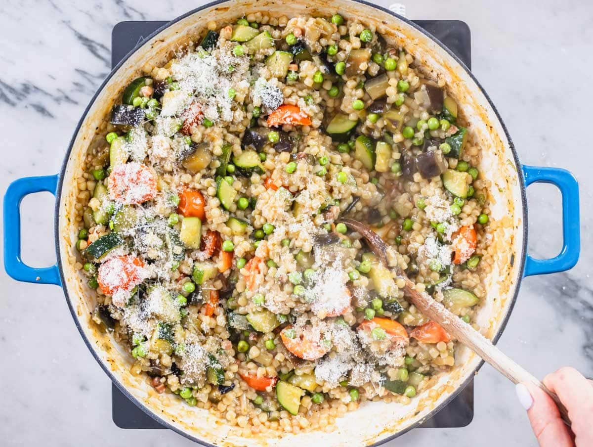 Fregola with vegetables and a sprinkle of parmesan cheese