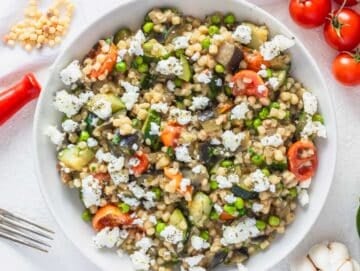 Fregola pasta with vegetables and crumbled feta