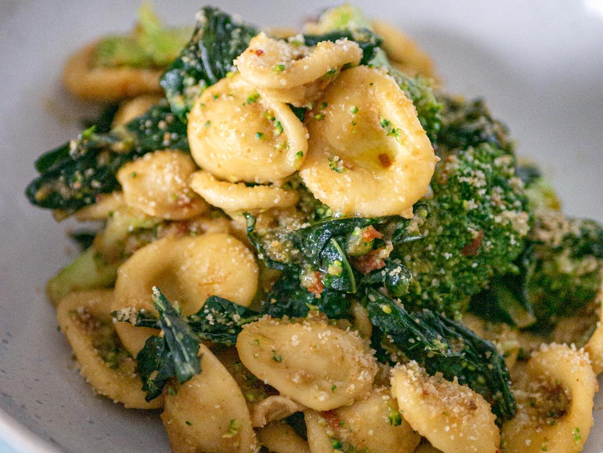 Homemade orecchiette with broccoli rabe on a white plate