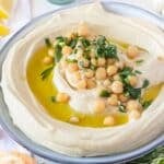 Hummus on a plate with parsley and olive oil