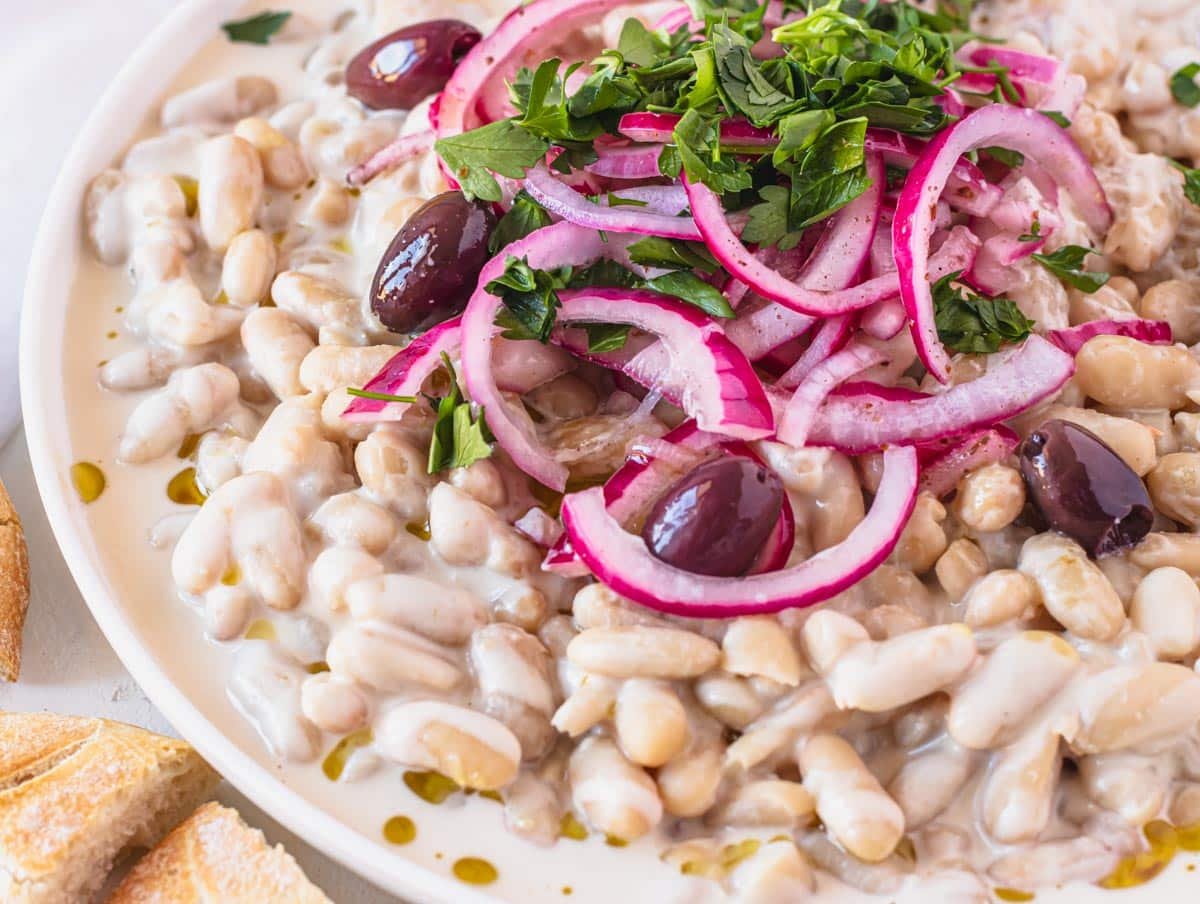 Piyaz with olives and marinated red onions on a plate