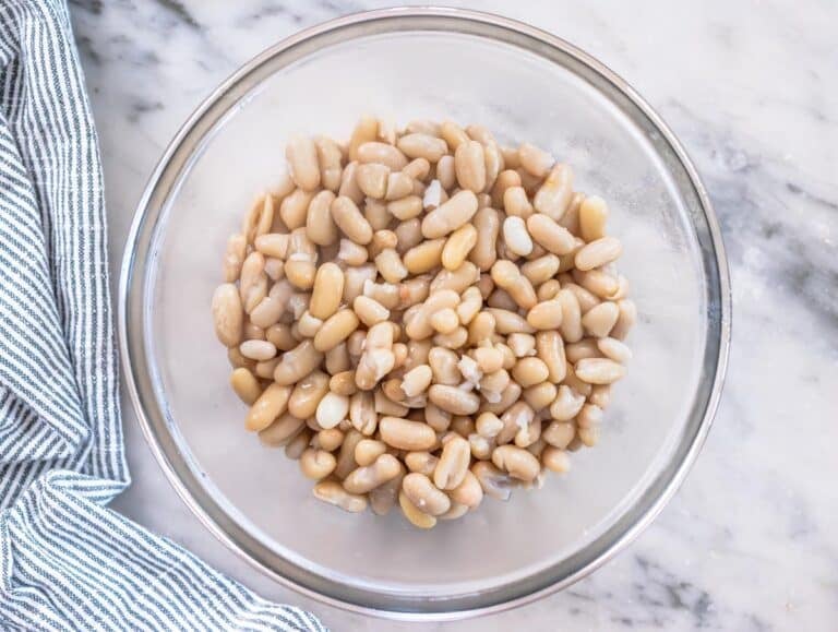 cooked white beans in a glass bowl