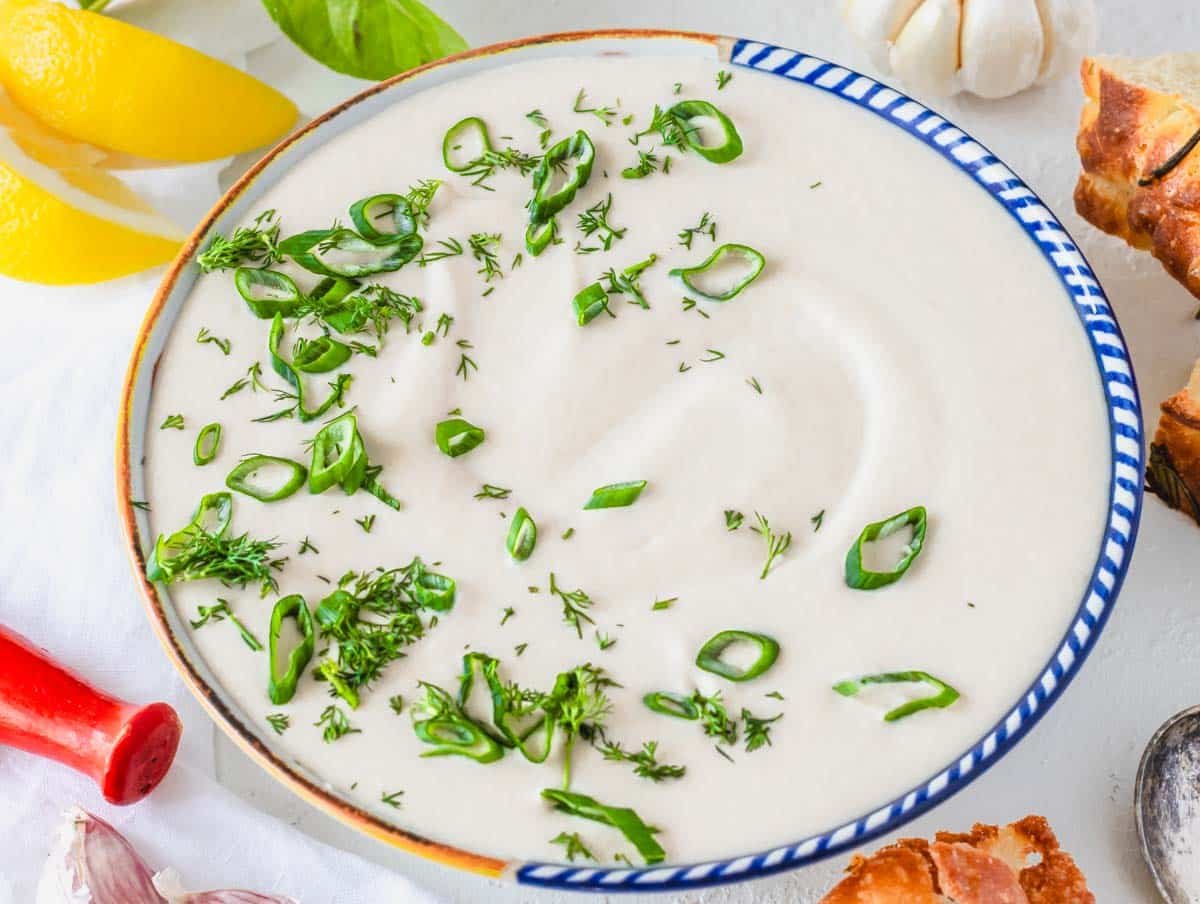 White bean dip in a Mediterranean bowl with scallions and dill