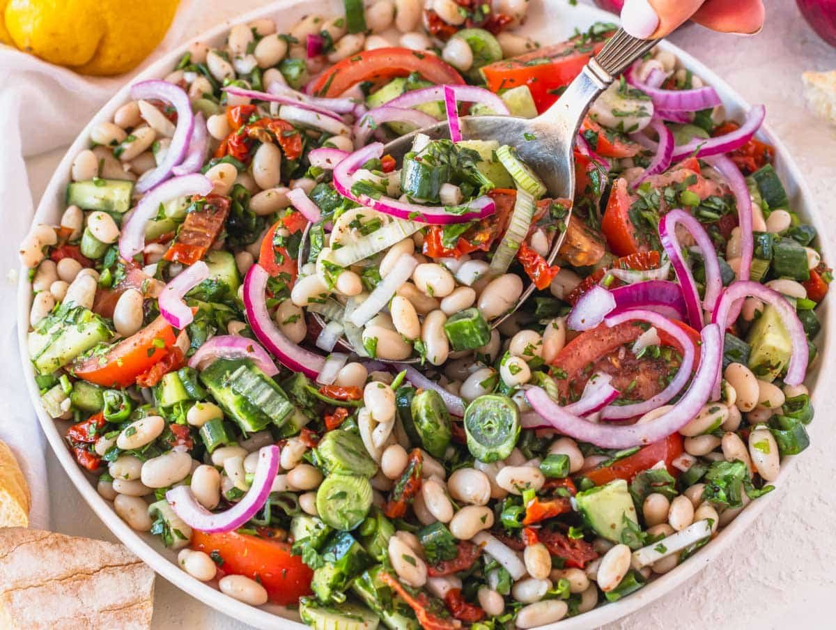 White bean salad with sumac onions and a silver spoon