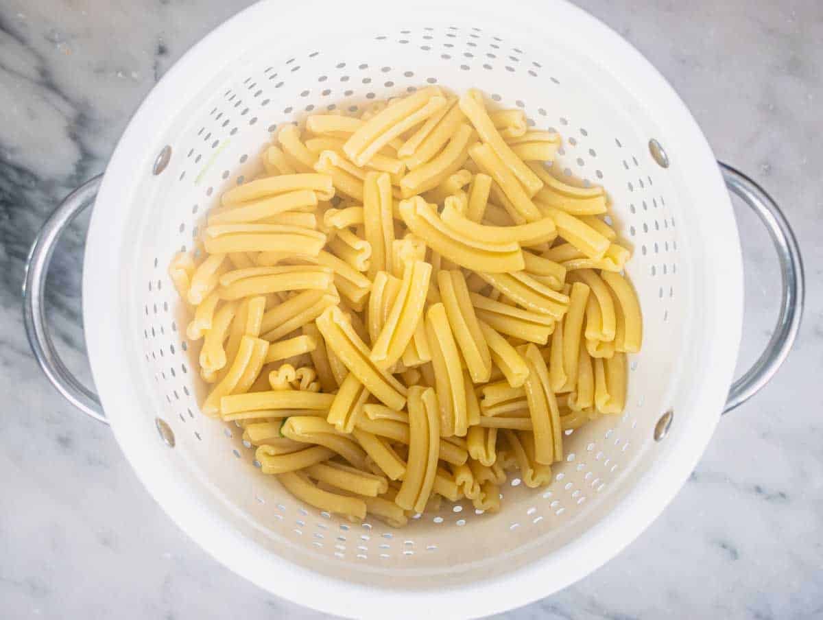 Cavatelli pasta after cooking in a white sift