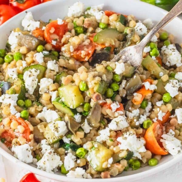 creamy fregola with peas, zucchini and cherry tomatoes