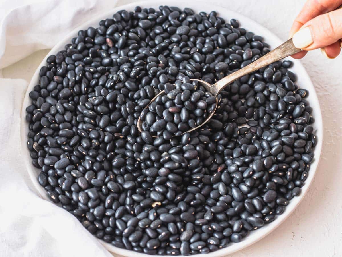 dried black beans on a white plate