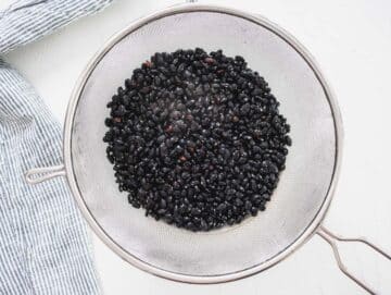 rinsed black beans in a sift