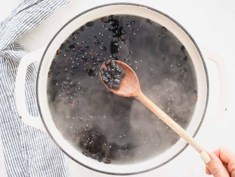 black beans in a white pot with boiling water