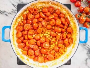 chickpeas and cherry tomatoes sautèeing in a pan