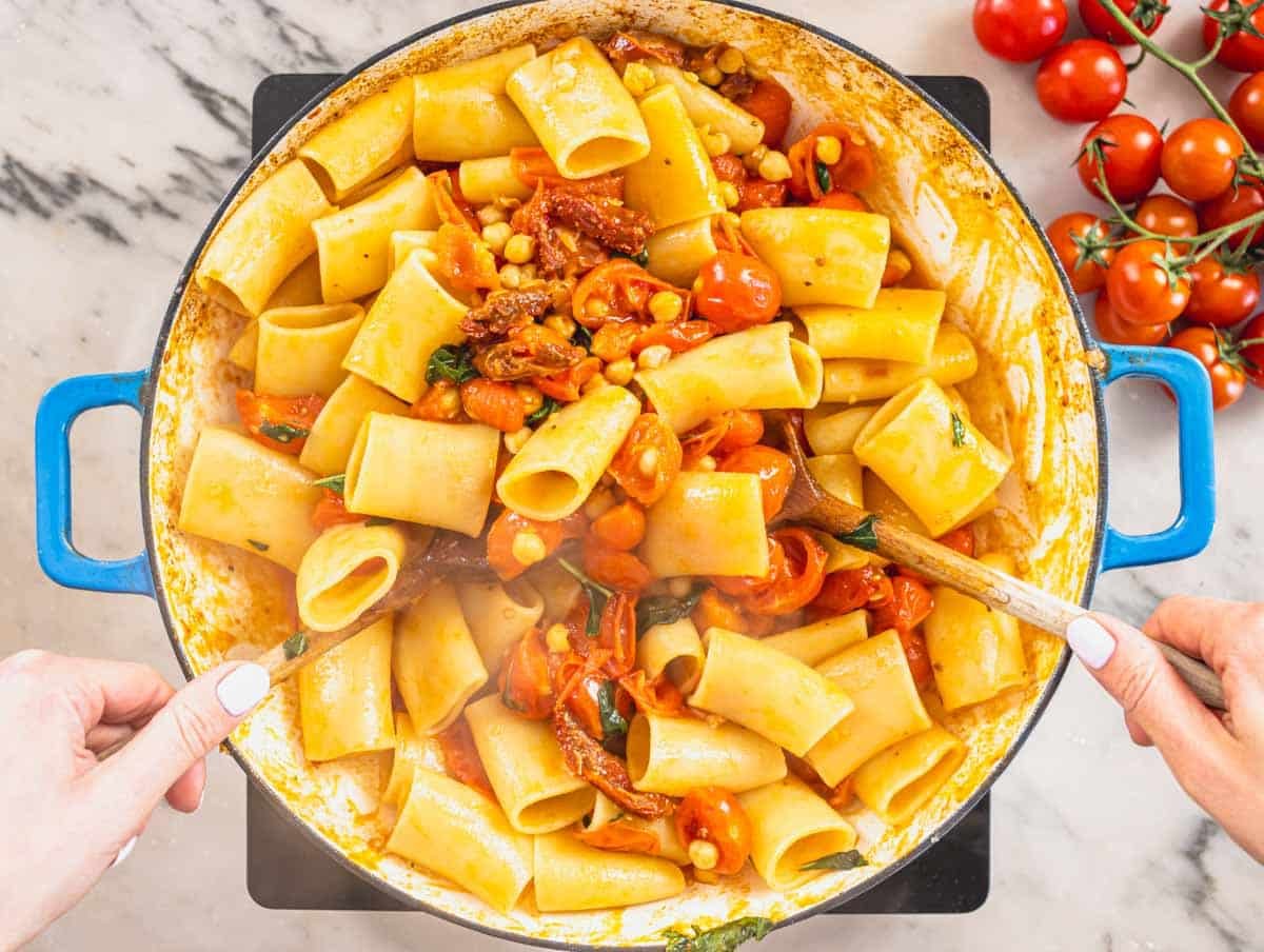 paccheri pasta, chickpeas and cherry tomatoes in a blue skillet