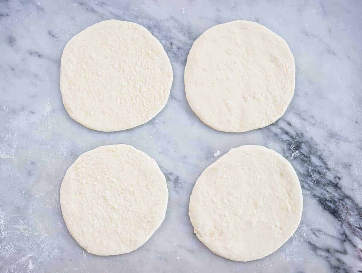 flat pizza dough before baking