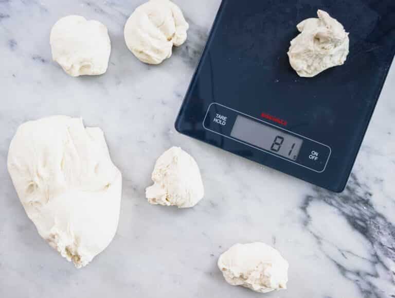 pita dough balls on a scale