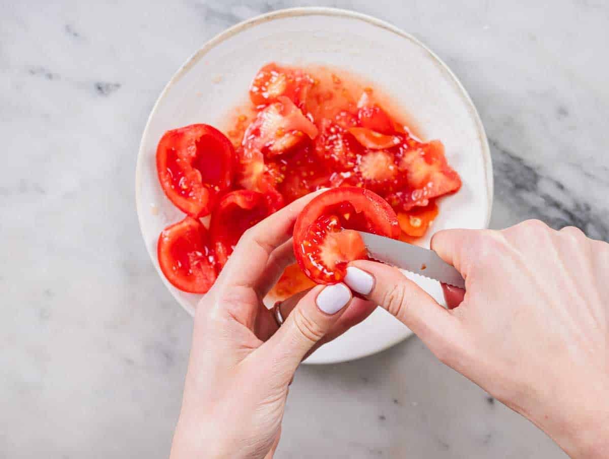 removing the seeds from vine tomatoes with a pairing knife