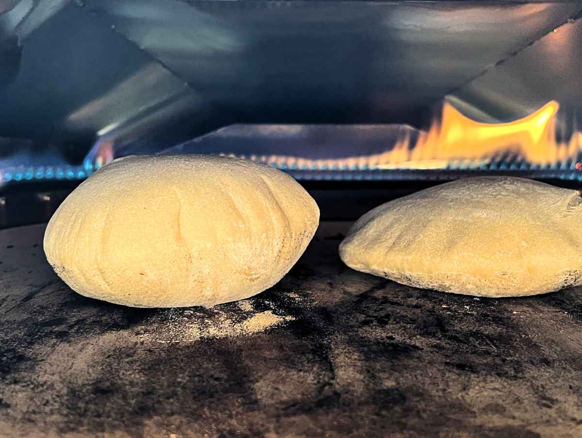 puffed up pitas in an Ooni pizza oven