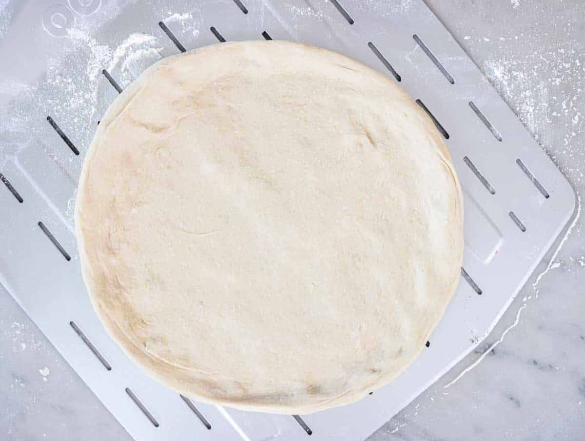 Neapolitan pizza dough on pizza peel