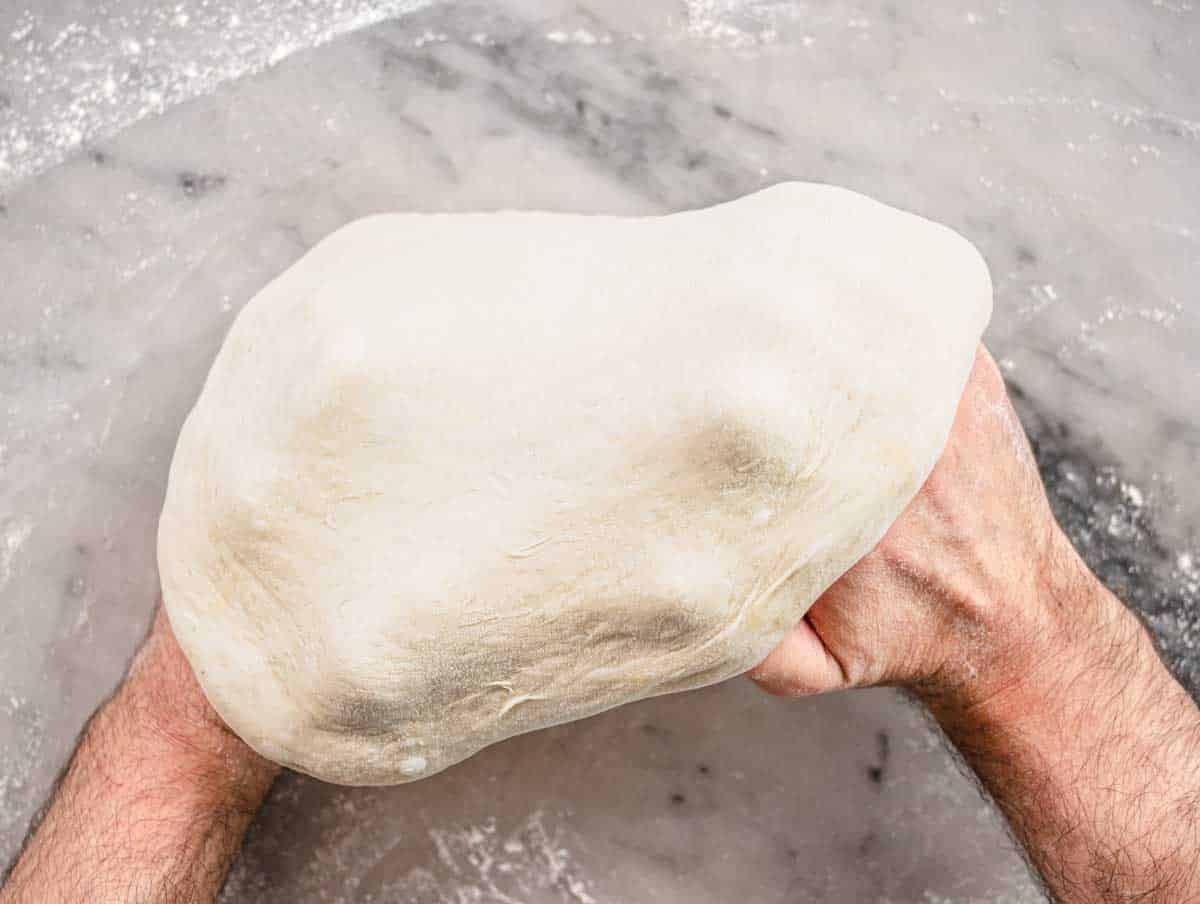 stretching the dough over knuckles