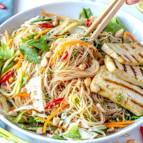 Asian noodle salad with grilled tofu in a white bowl