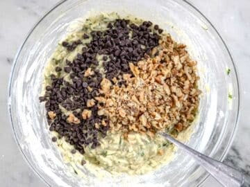 Banana Zucchini bread batter with chopped walnuts and chocolate chips in a glass bowl