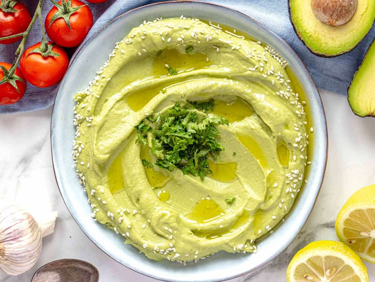 Creamy Avocado spread on a blue plate.