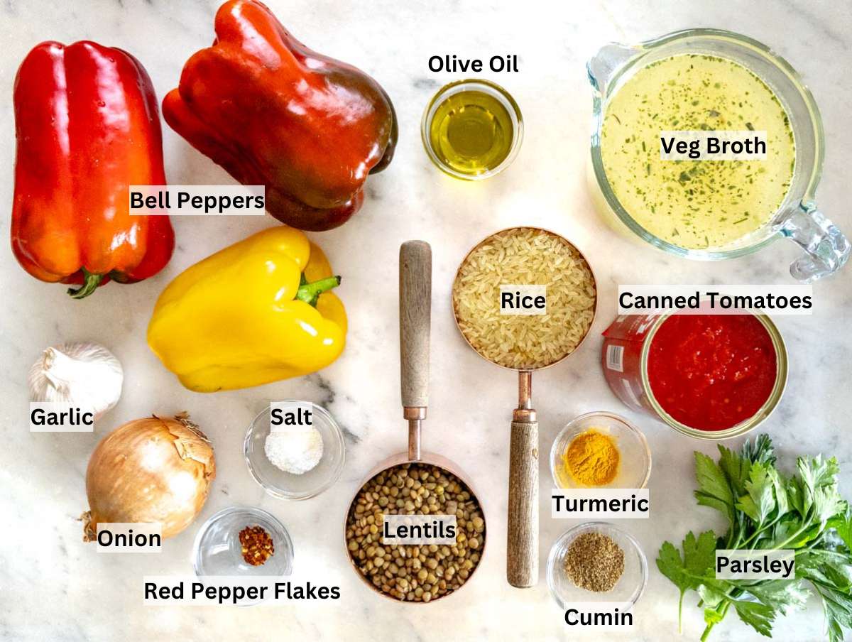 Ingredients for stuffed bell peppers on a marble table.