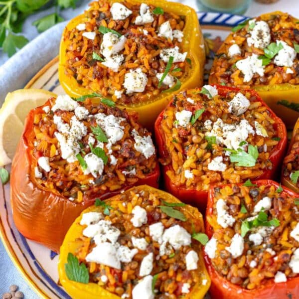 Oven-baked Mediterranean stuffed bell peppers filled with rice, lentils, and herbs, served as a wholesome and colorful vegetarian main dish.