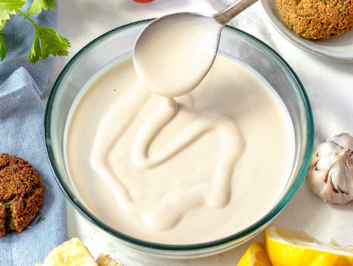 Tahini sauce with lemon and falafel on the side