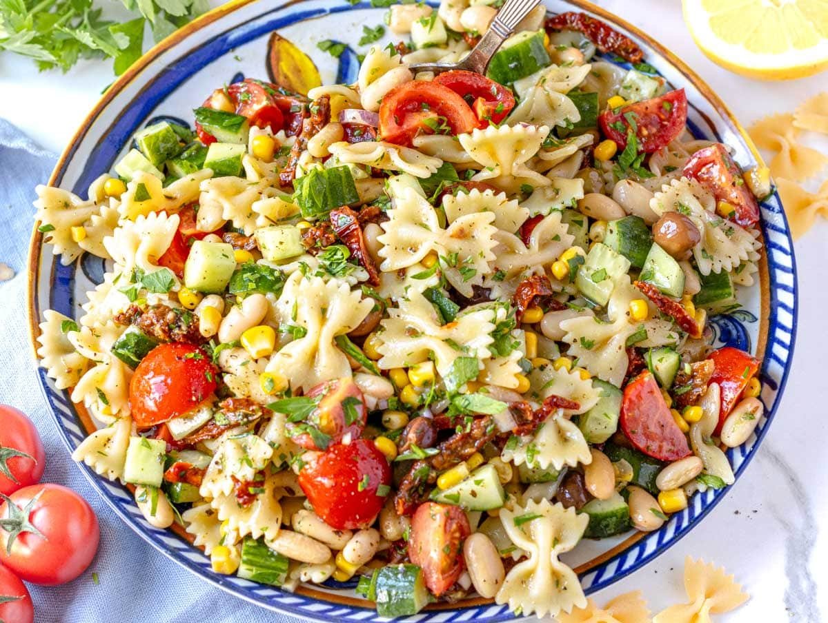 Vegan Pasta Salad on a Mediterranean plate with cherry tomatoes