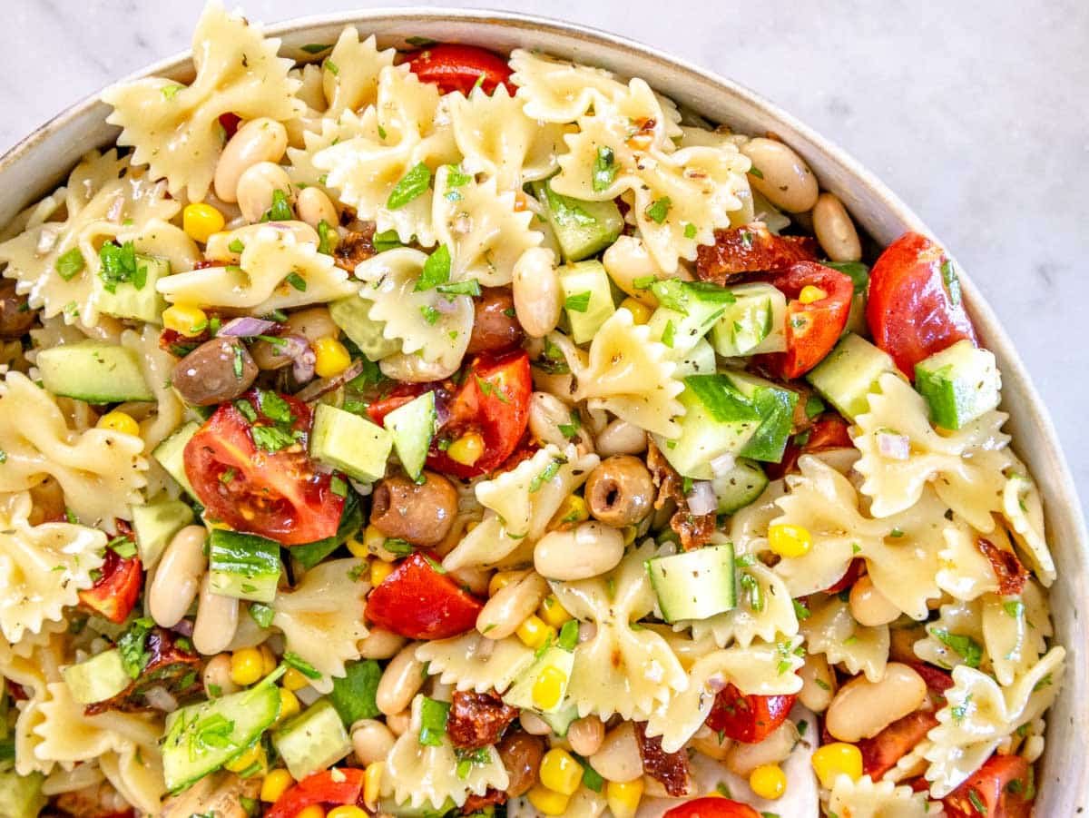 Vegan Pasta Salad after mixing in a white bowl