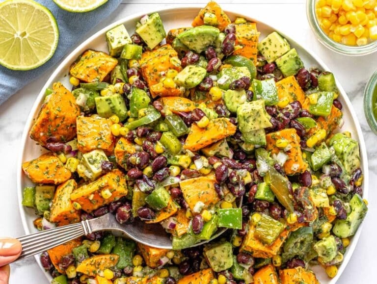 black bean salad with a female hand and lime on the side