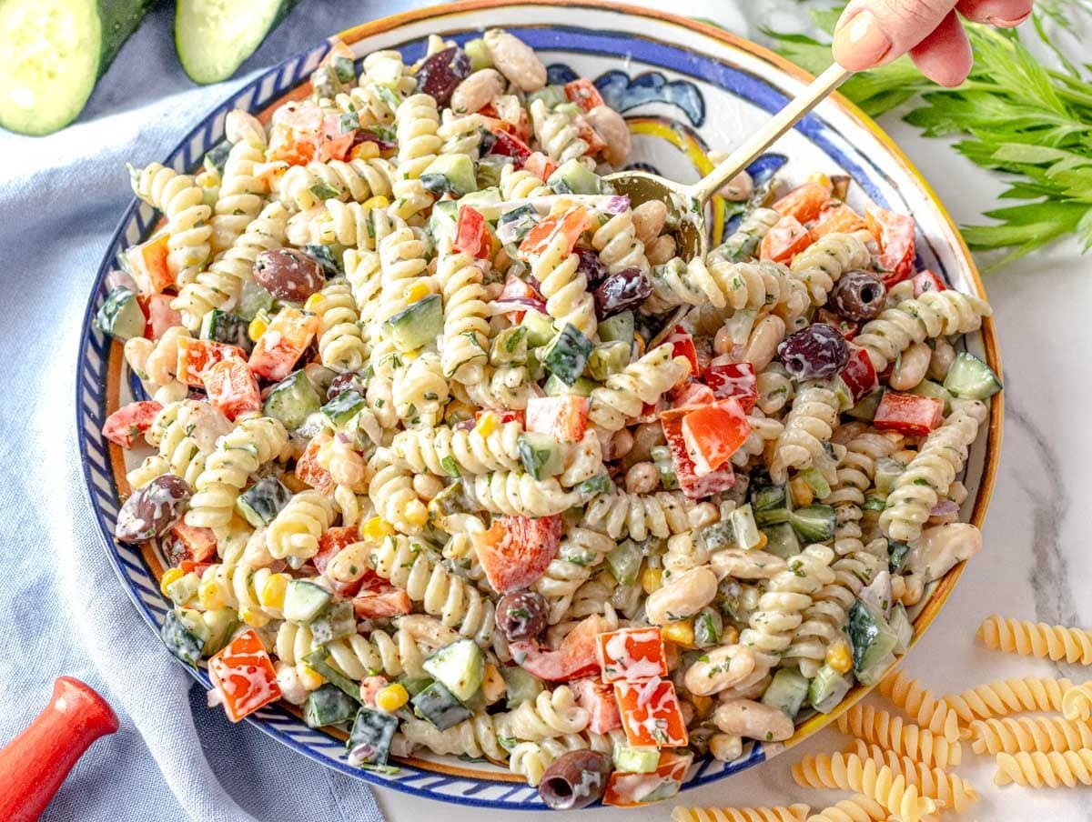 creamy pasta salad served on a blue plate