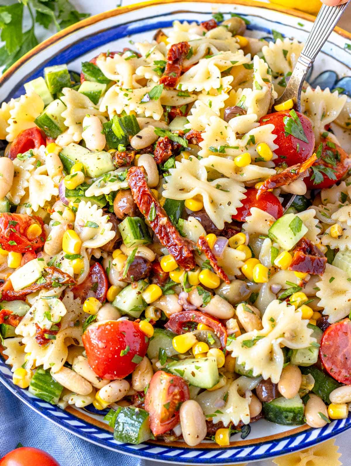 easy pasta salad with cherry tomatoes and white beans on a blue plate