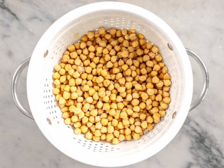 soaked and drained chickpeas in a white sift