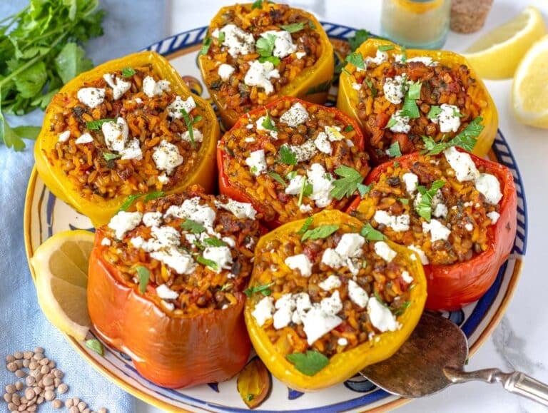 stuffed bell peppers sprinkled with feta cheese and served on a plate