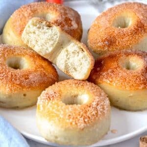 vegan donuts with sugar on a white plate with a blue cloth