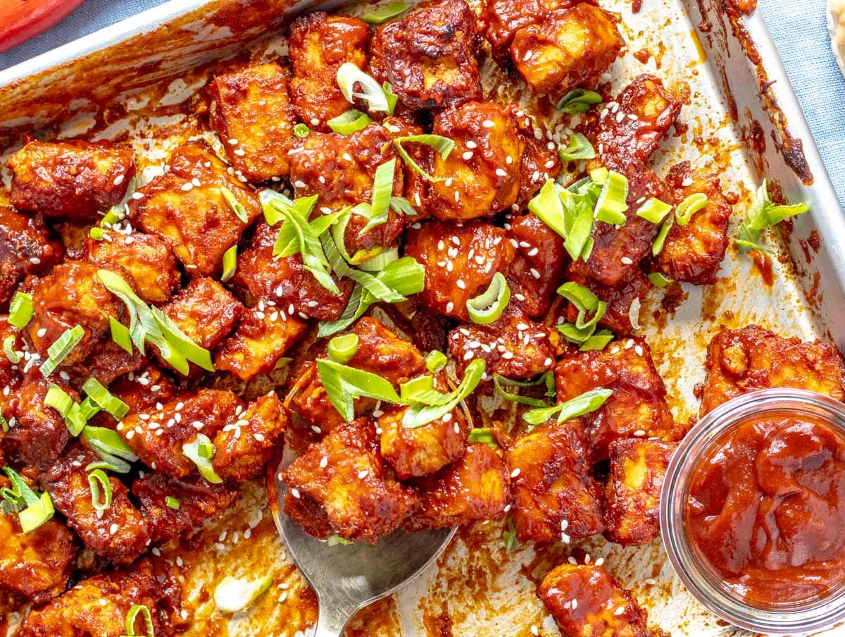 BBQ tofu on a baking tray with scallions