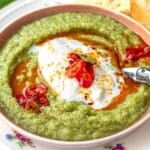 Broccoli soup with burrata cheese and a spoon