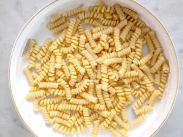 cooked short pasta in a white bowl