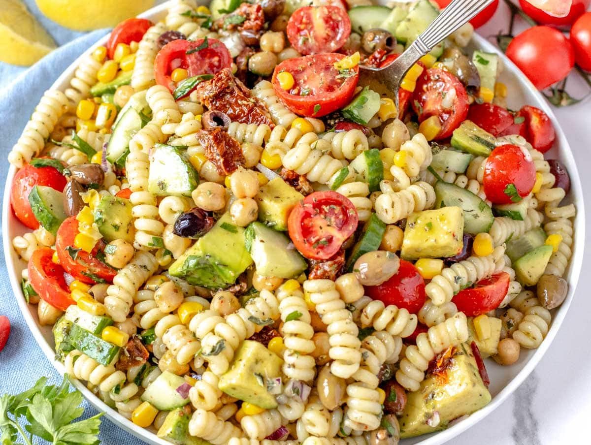 Chickpea Pasta Salad served on a white plate with a spoon