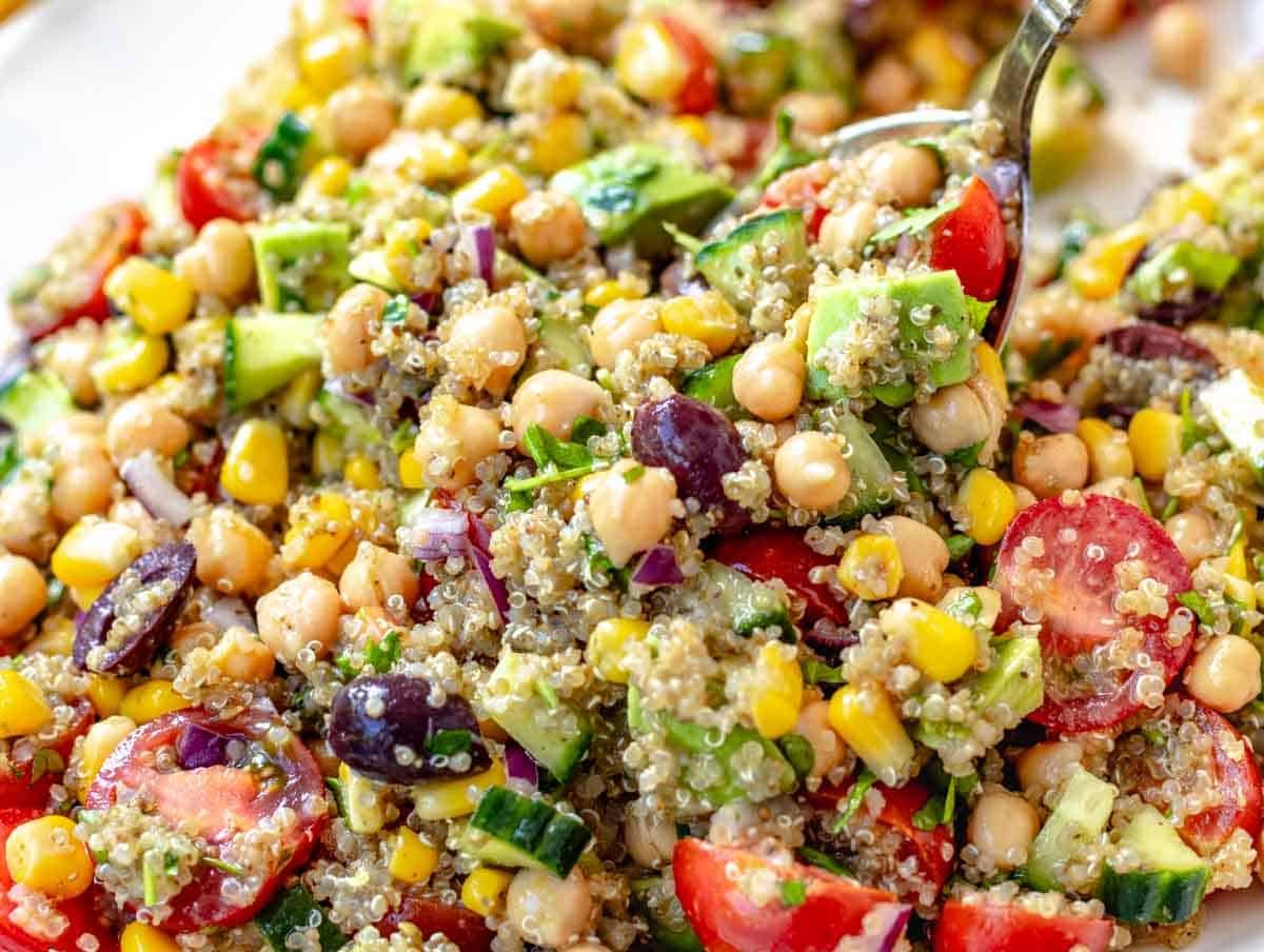 Chickpea quinoa salad with a silver spoon on a big platter