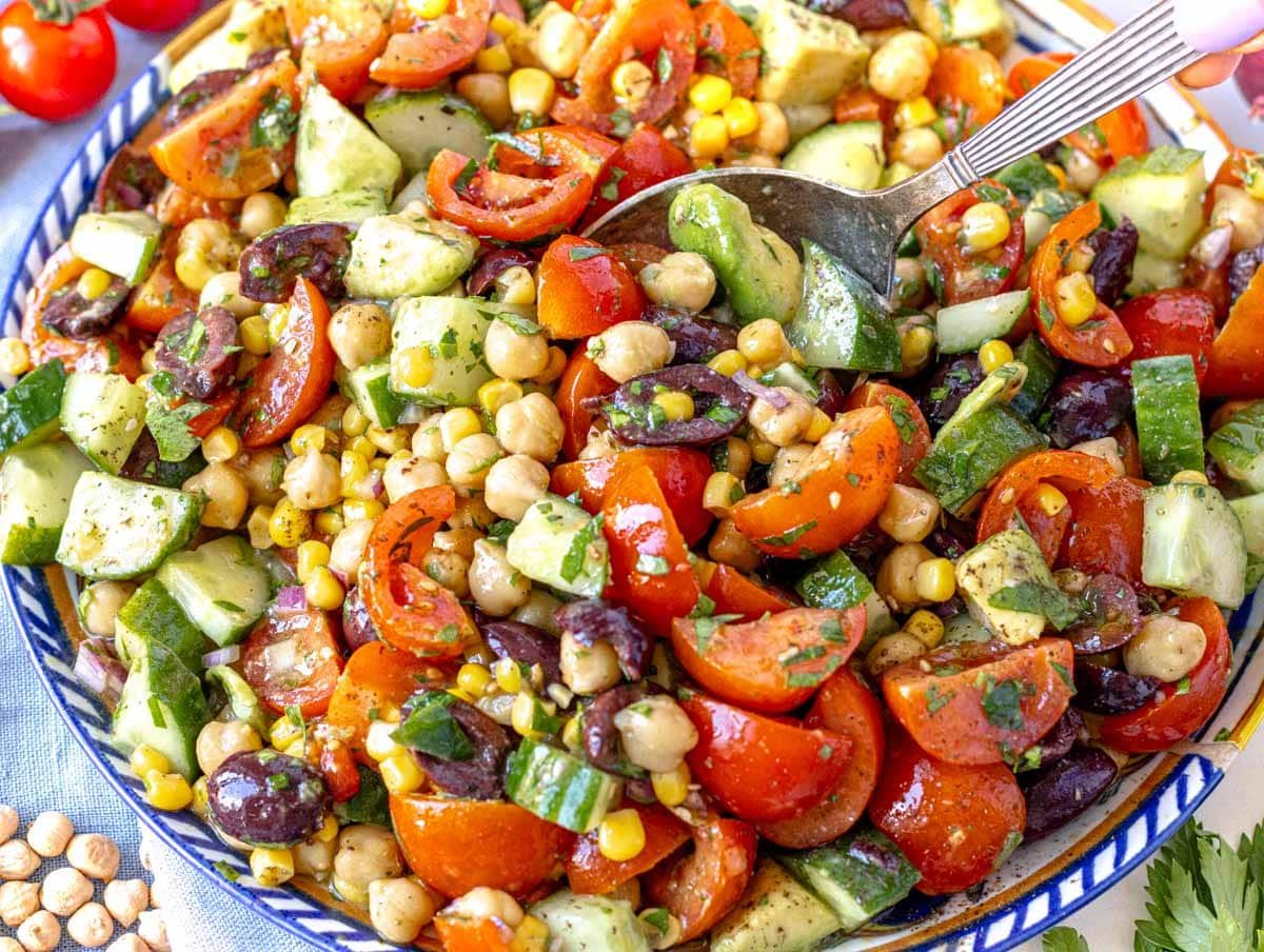 Chickpea salad after mixing and serving on a plate with a spoon
