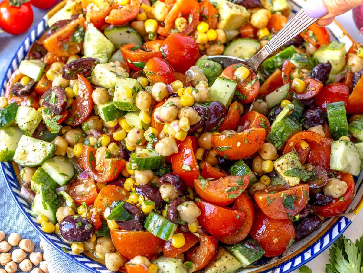 Chickpea salad on a plate with cucumber and tomatoes