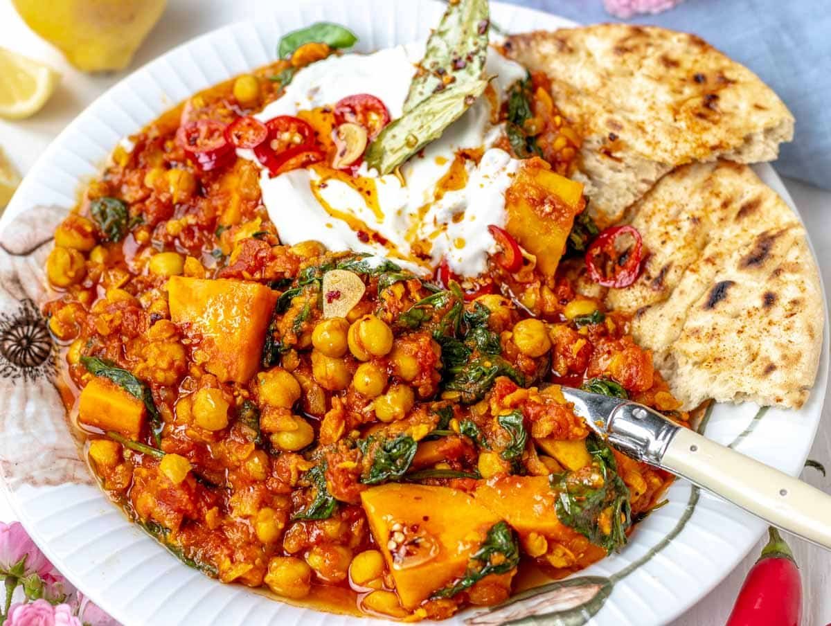 Chickpea stew with a spoon, yogurt and Naan bread