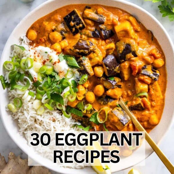 Creamy eggplant curry recipe served with basmati rice, fresh herbs, and a wedge of lime.