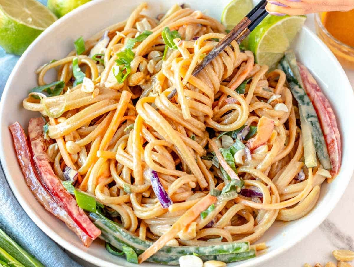 Peanut noodles with chopsticks and veggies